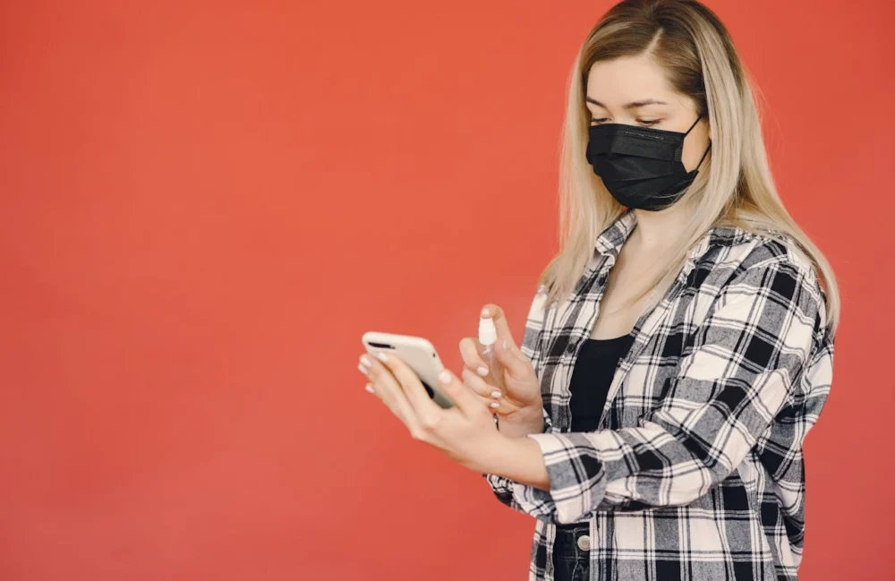 woman trying the Best Antimicrobial Spray for Phones