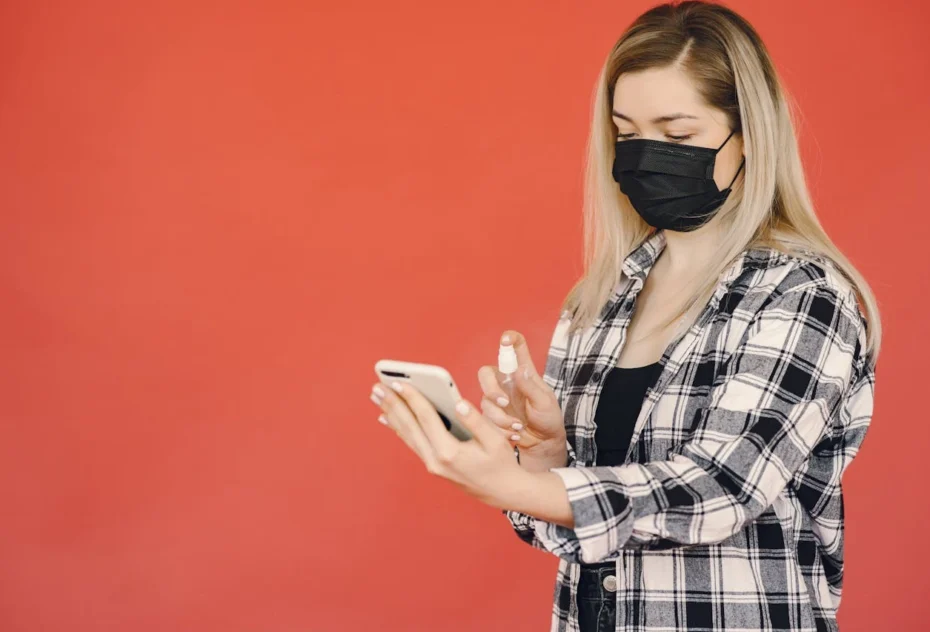 woman trying the Best Antimicrobial Spray for Phones